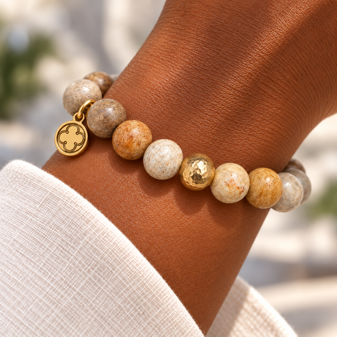 Fossil Coral with Hammered Gold Accent on a woman’s wrist