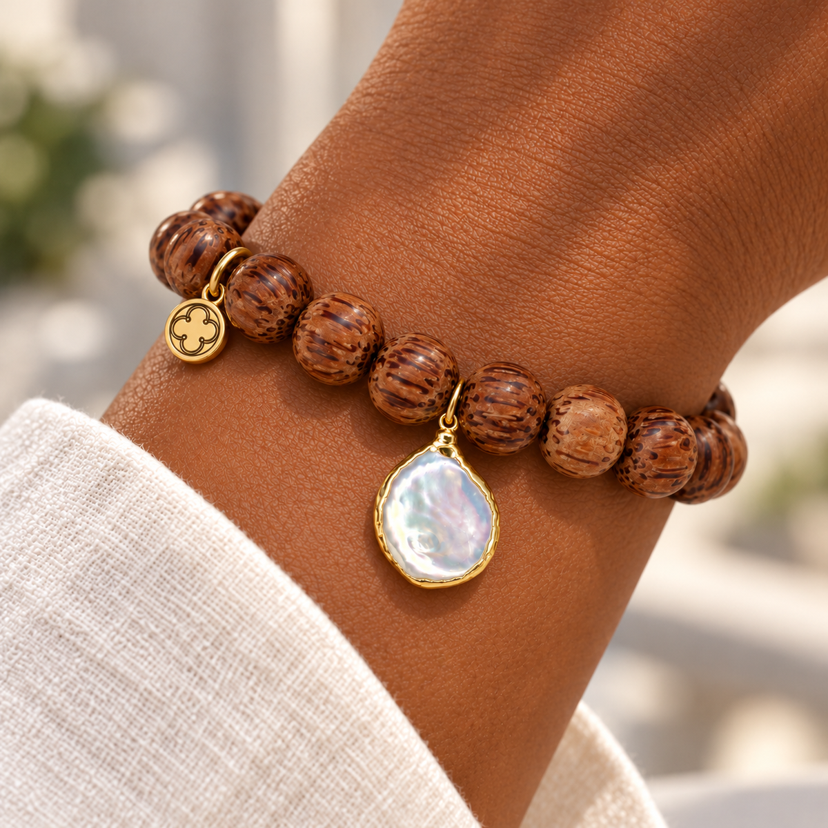 Coconut Wood with Freshwater Pearl Pendant on a woman’s wrist