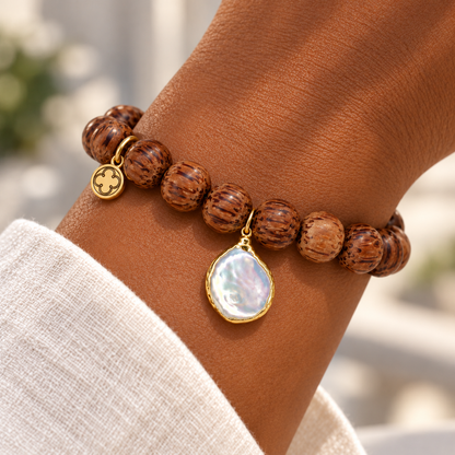 Coconut Wood with Freshwater Pearl Pendant on a woman’s wrist