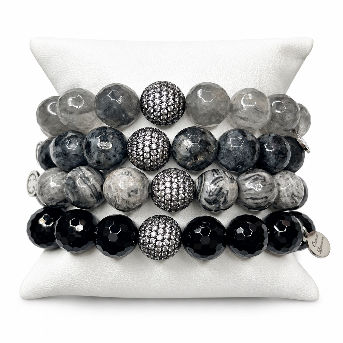 Fifty Shades of Darker Grey Gemstones Armparty on white studio background