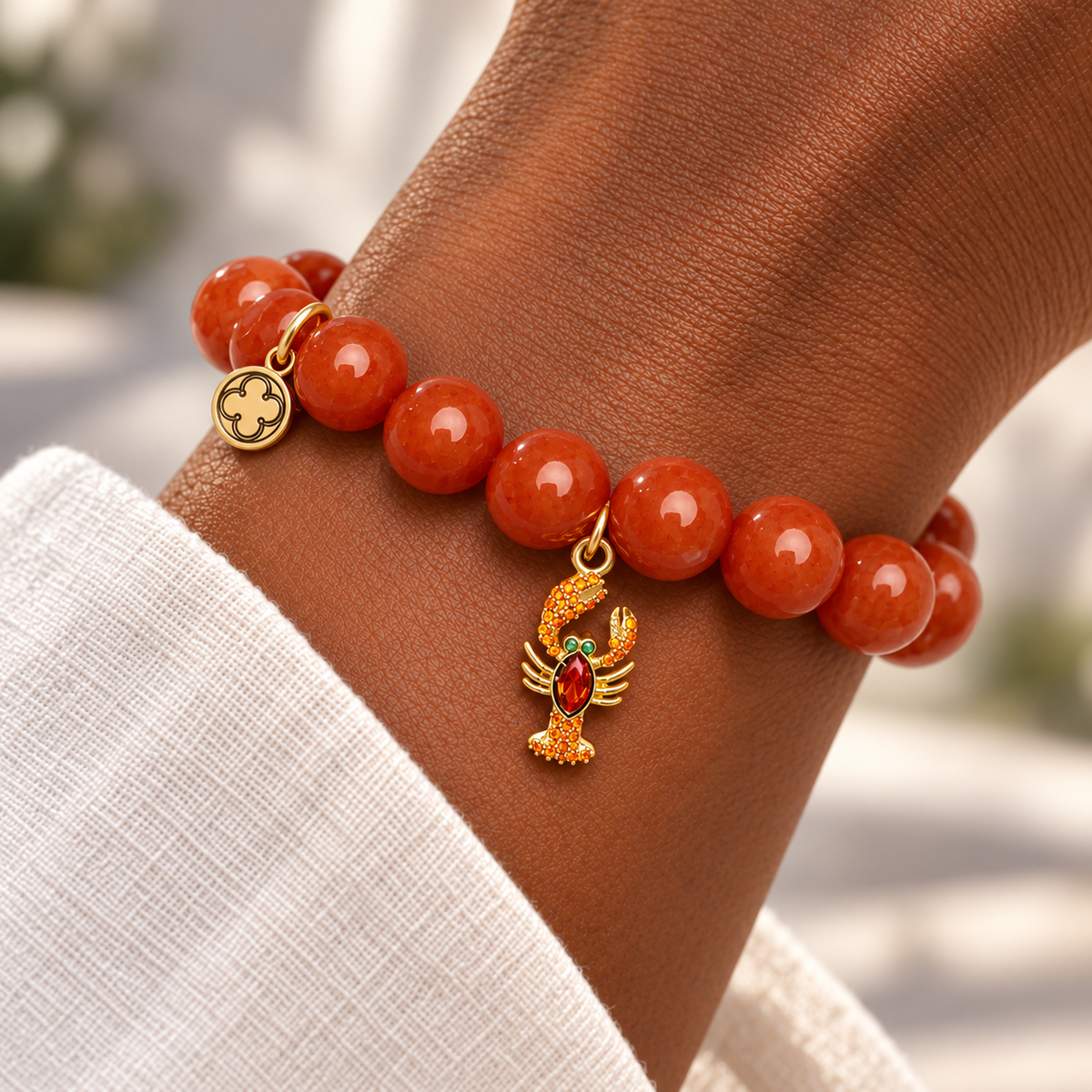 Fire Jade with Pavé Lobster Pendant on a woman’s wrist