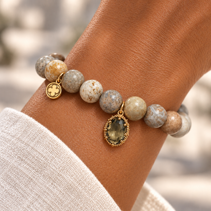 Fossil Coral with Pavé Topaz Glass Teardrop on a woman’s wrist