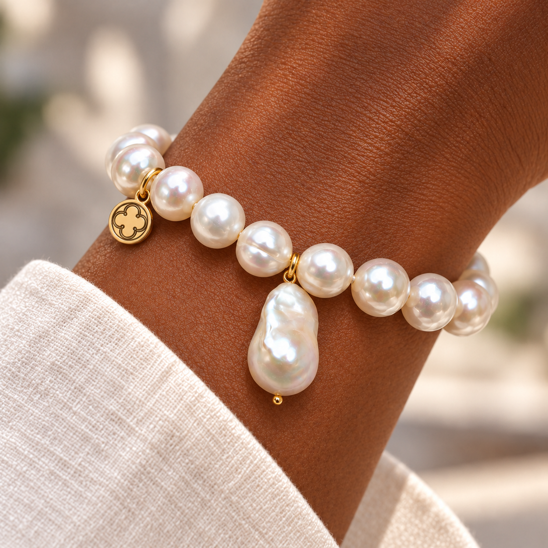 Freshwater Pearls with Baroque Pearl Drop Pendant on a woman’s wrist