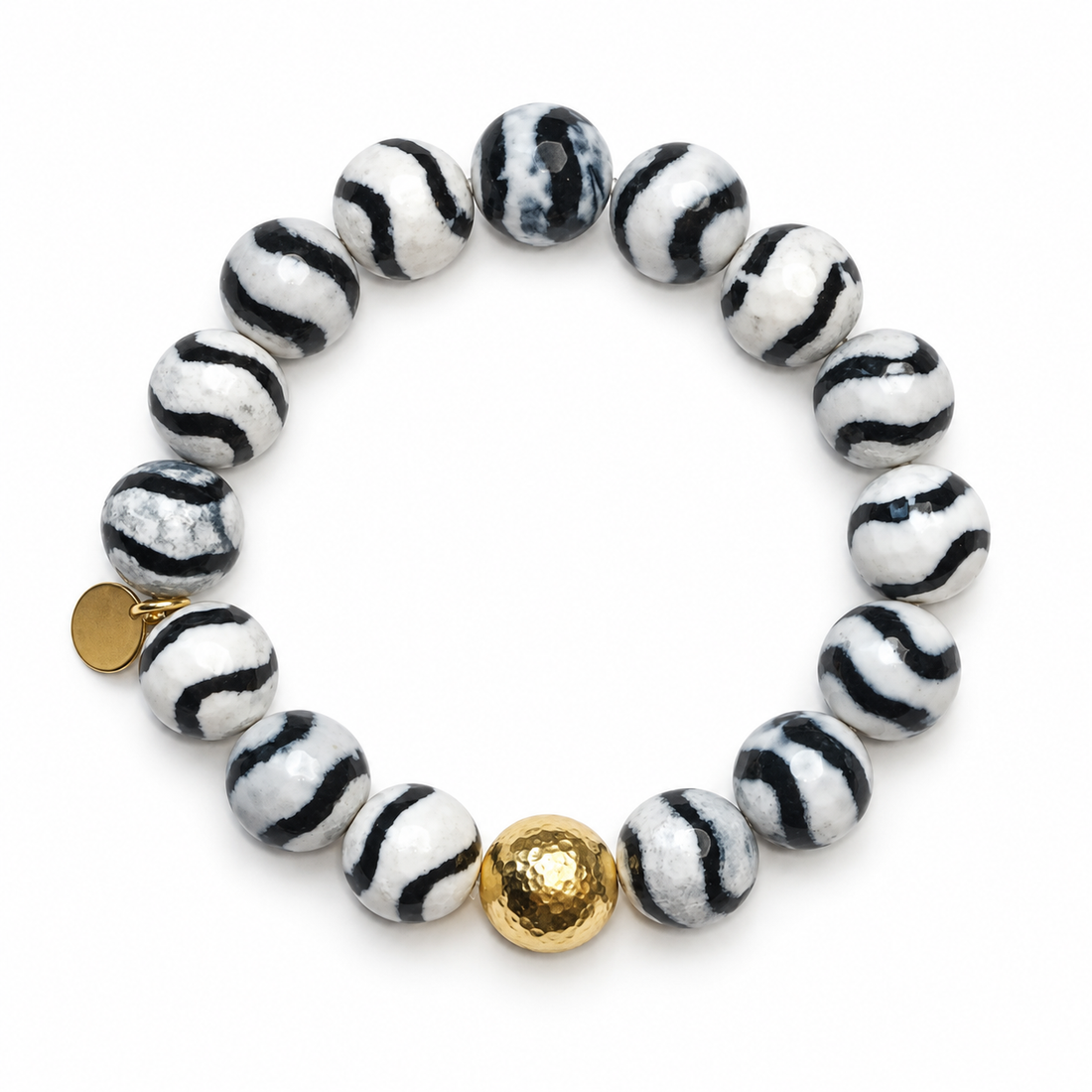 Tibetan Black Wave Agate with Gold Hammered Accent on a white background