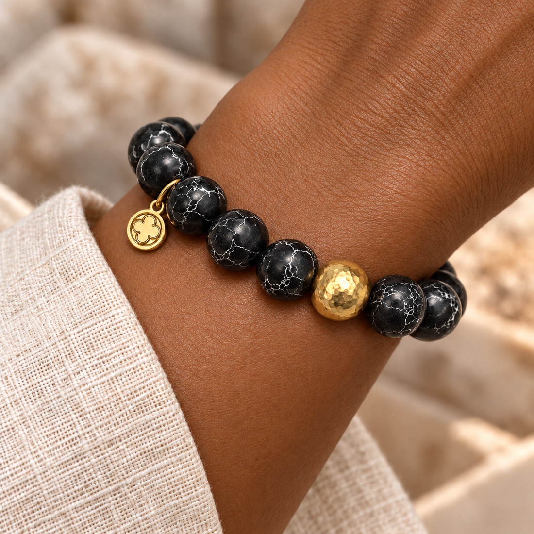 Black Howlite with Hammered Gold Accent bracelet worn on a woman&
