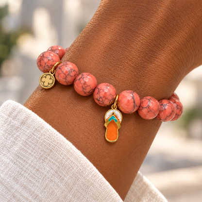 Coral Pink Howlite with Flip Flop Pendant on a woman’s wrist