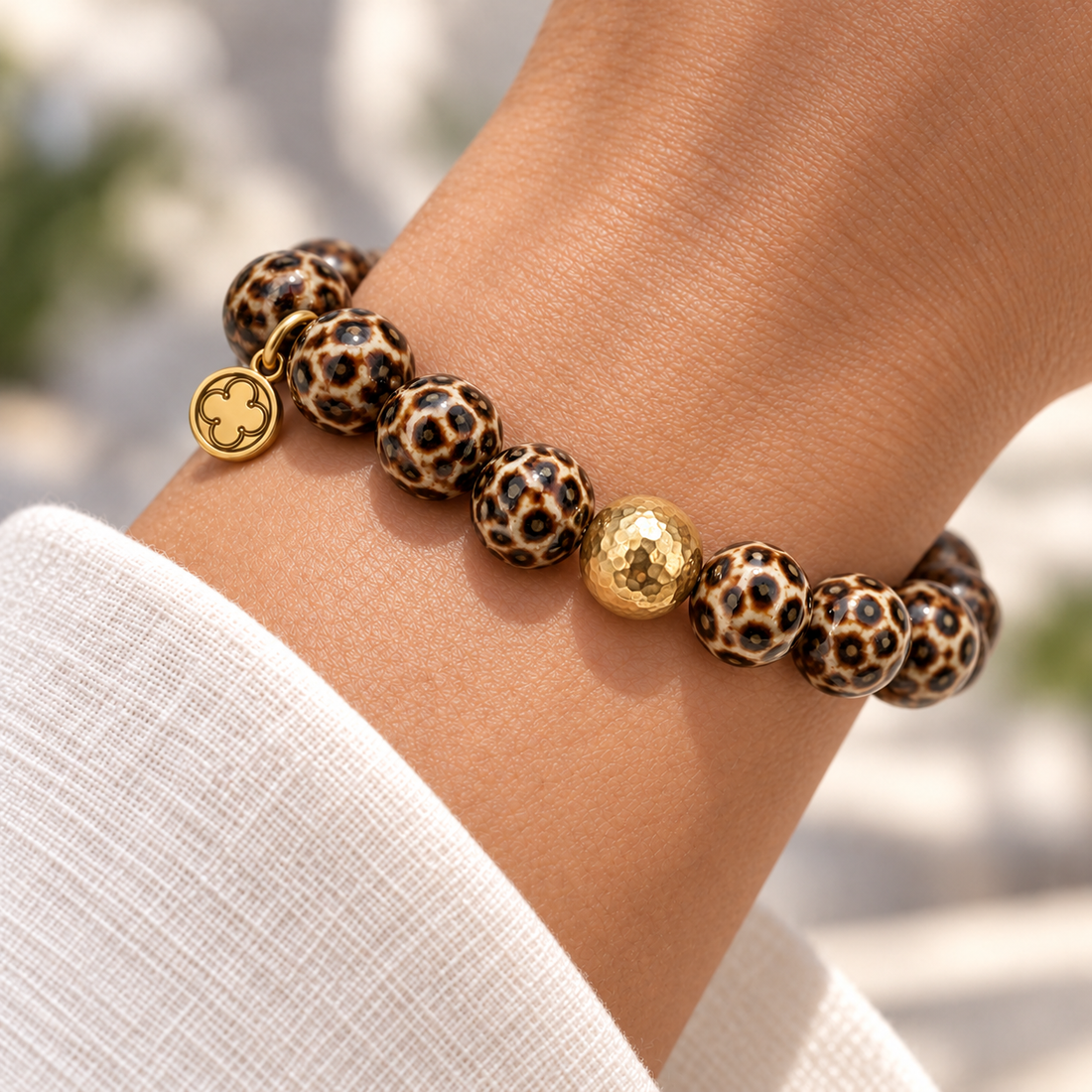 Dark Brown Leopard Ceramic with Hammered Gold Accent on a woman’s wrist
